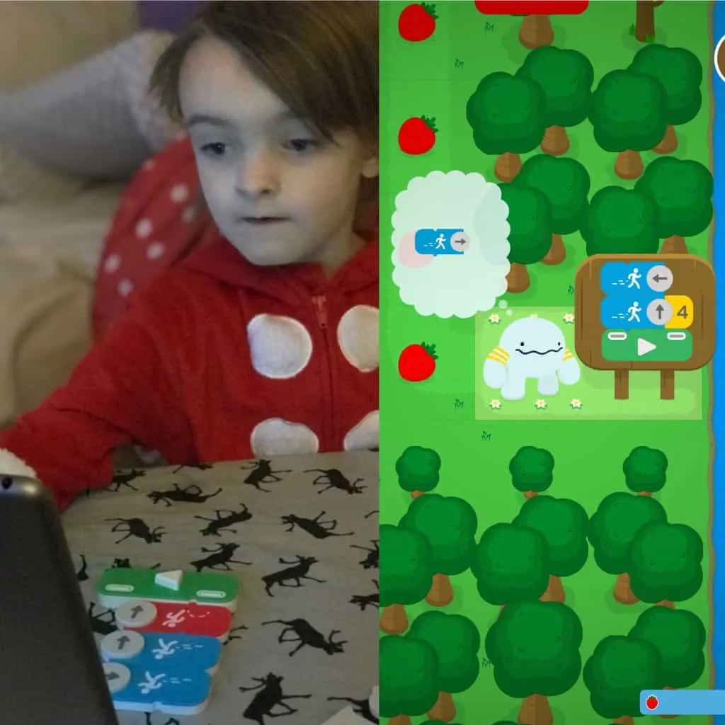 A picture of a kid playing coding awbie game.