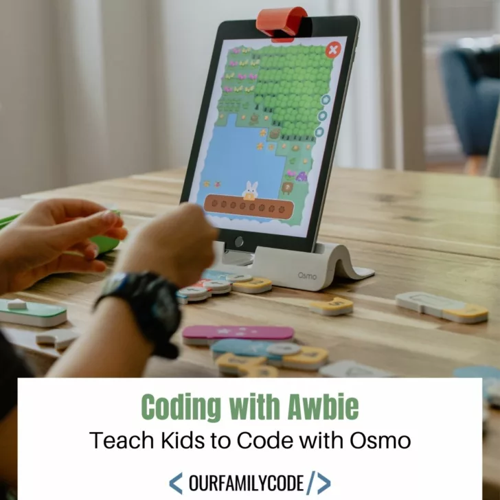 A picture of a kid playing Coding Awbie game from Osmo with text that says 