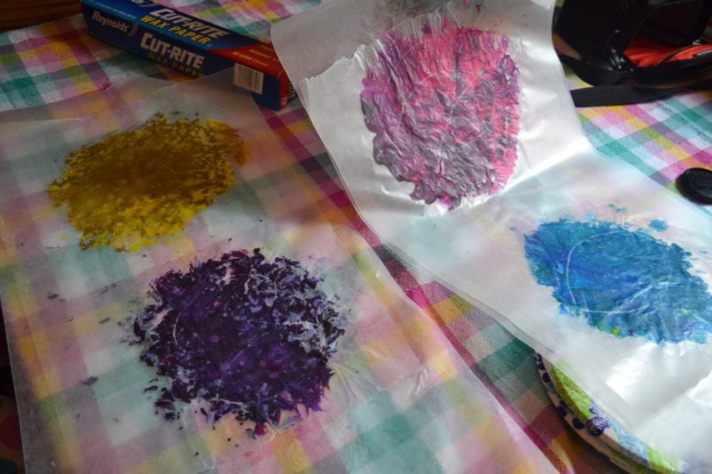 A picture of melted crayon shavings between wax paper.