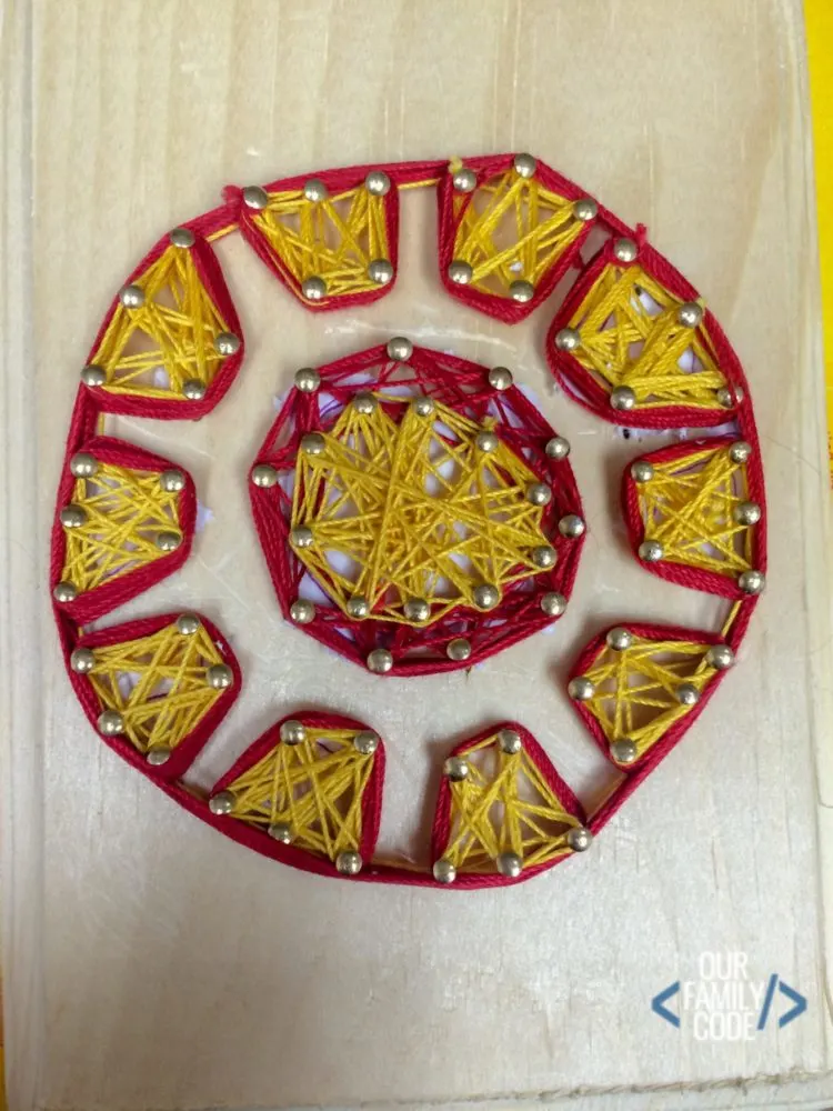 A picture of Iron Man superhero string art.