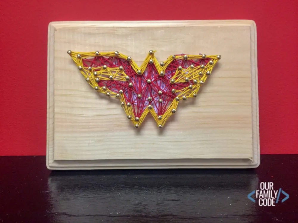 A picture of Wonder Woman superhero string art.