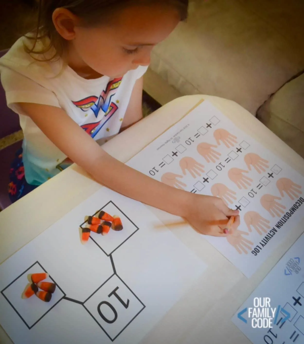 Your Preschooler or Kindergartner can learn addition and subtraction concepts by composing and decomposing the number 10 with this candy corn math activity! #kindergartenmath #homeschool #decomposingnumbers #halloweenmathactivity #mathactivity #preschoolmath #STEM #steamlearning #handsonlearning OurFamilyCode.com