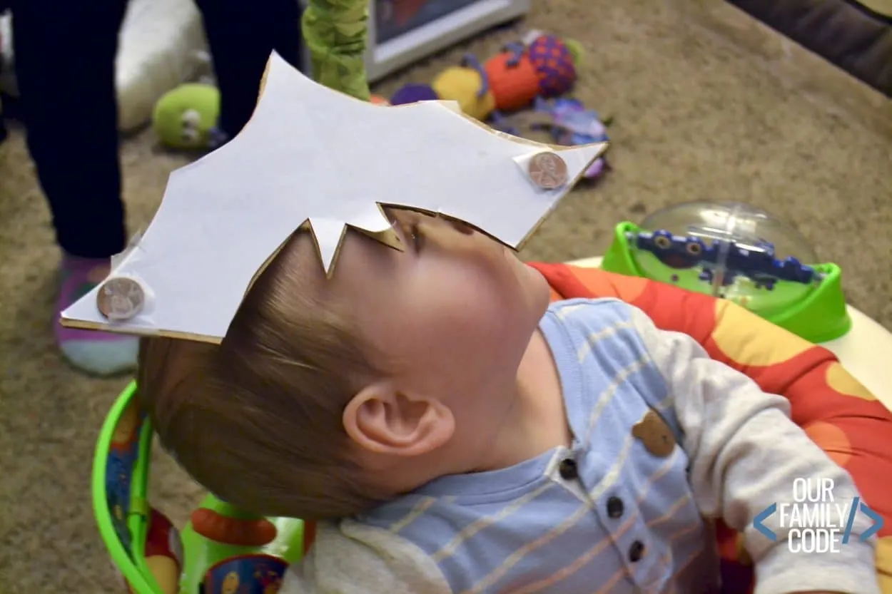 A photo of a kid balancing a bat on their head for a Stellaluna book activity. 