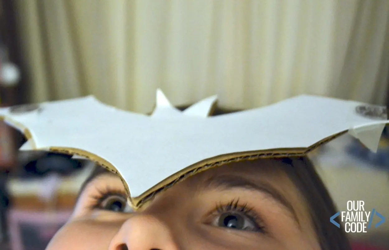 A photo of a kid balancing a bat on their head for a Stellaluna book activity. 