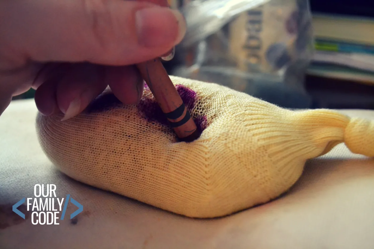 A picture of a warm sock with rice being used to heat crayons for art.