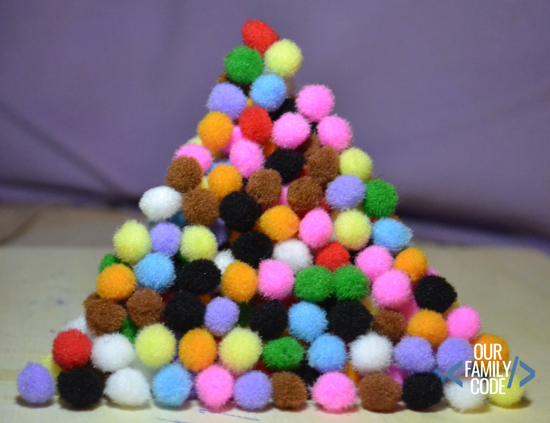 A picture of a tetrahedron built with pom pom balls to represent pascal's triangle. 