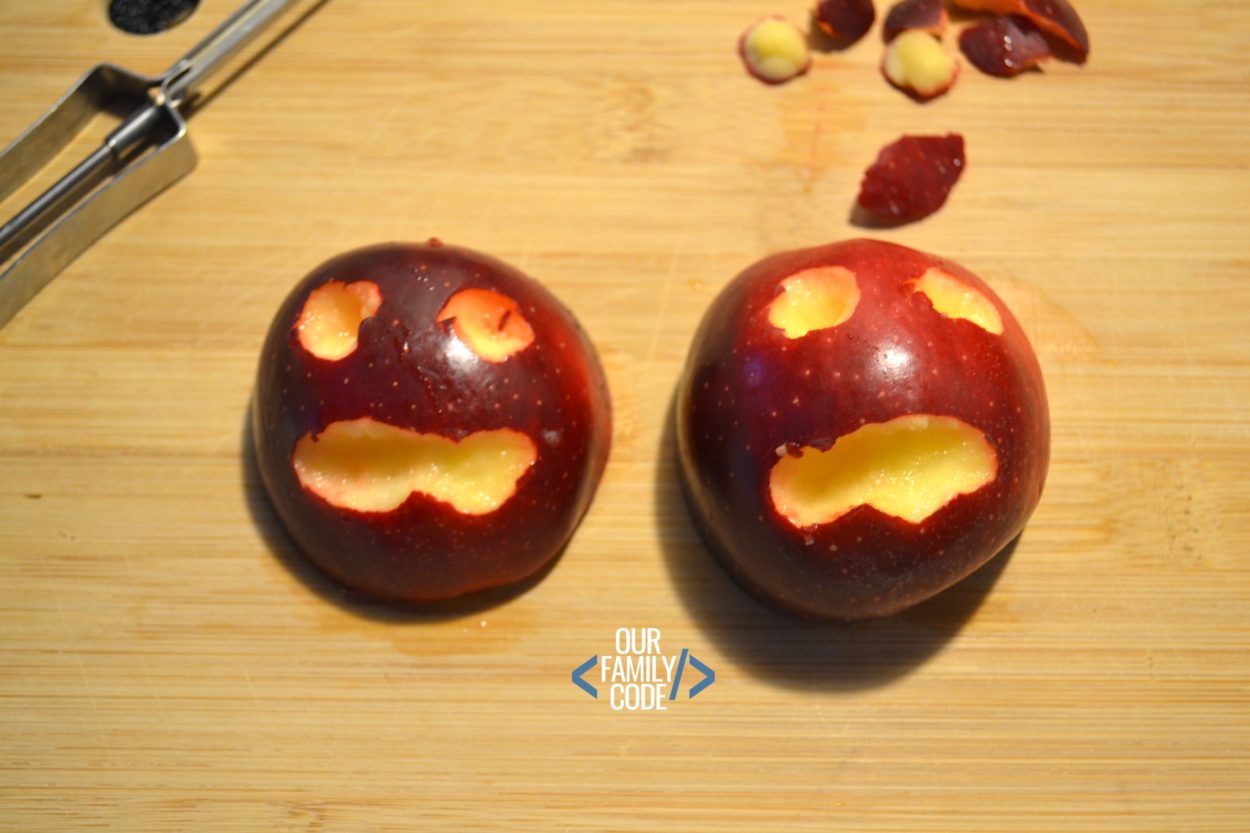 A picture of carved apple faces.