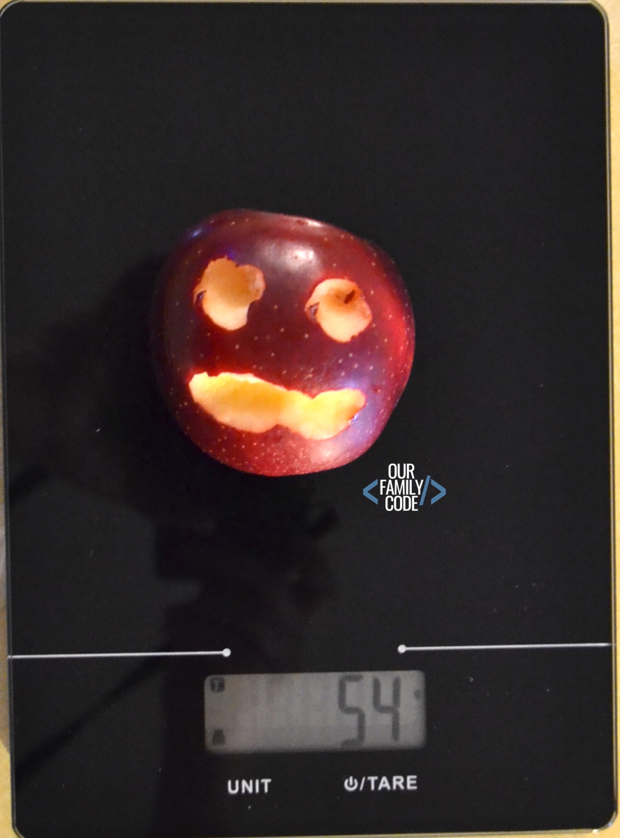A picture of an apple on a food scale.