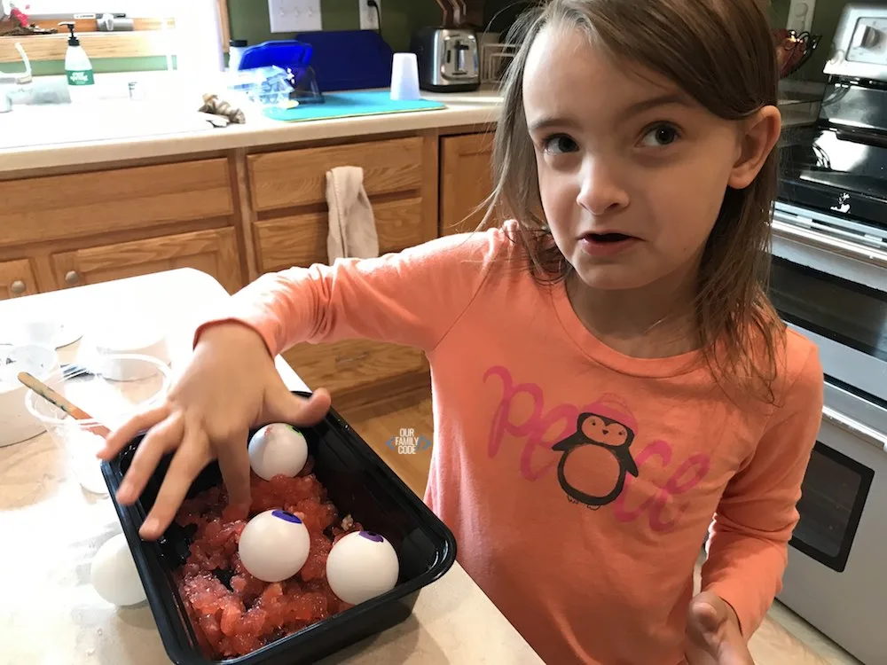 A picture of a girl touching slime.