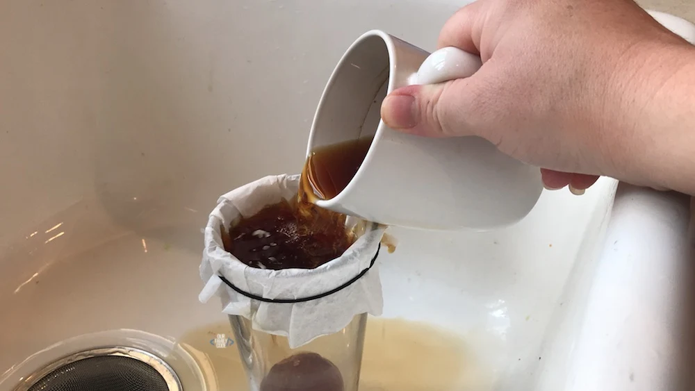 A picture of spider web science activity with sticky web made from eggs and black tea.