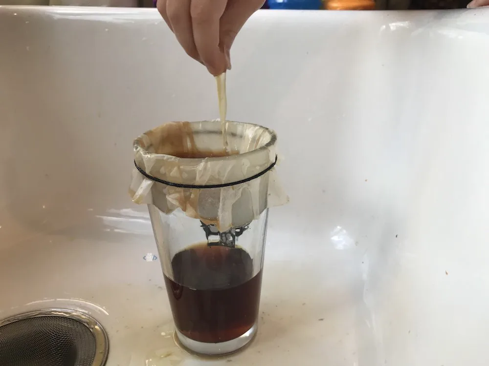 A picture of spider web science activity with sticky web made from eggs and black tea.