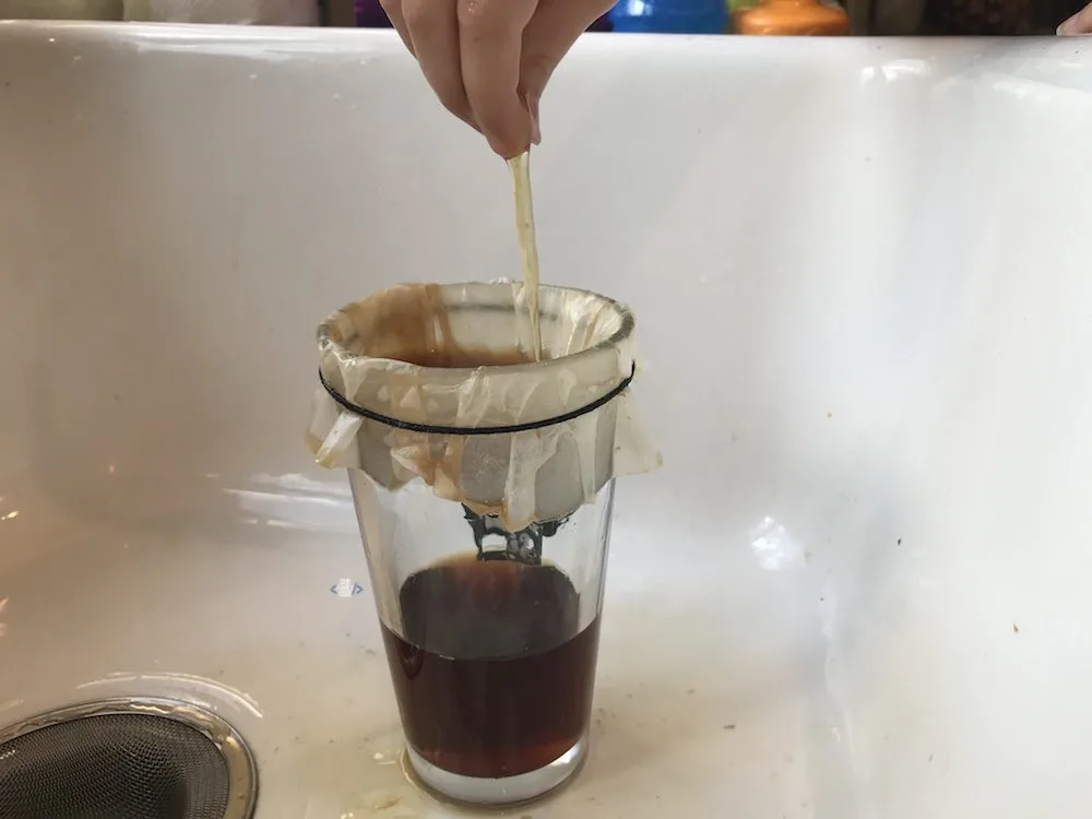 A picture of spider web science activity with sticky web made from eggs and black tea.