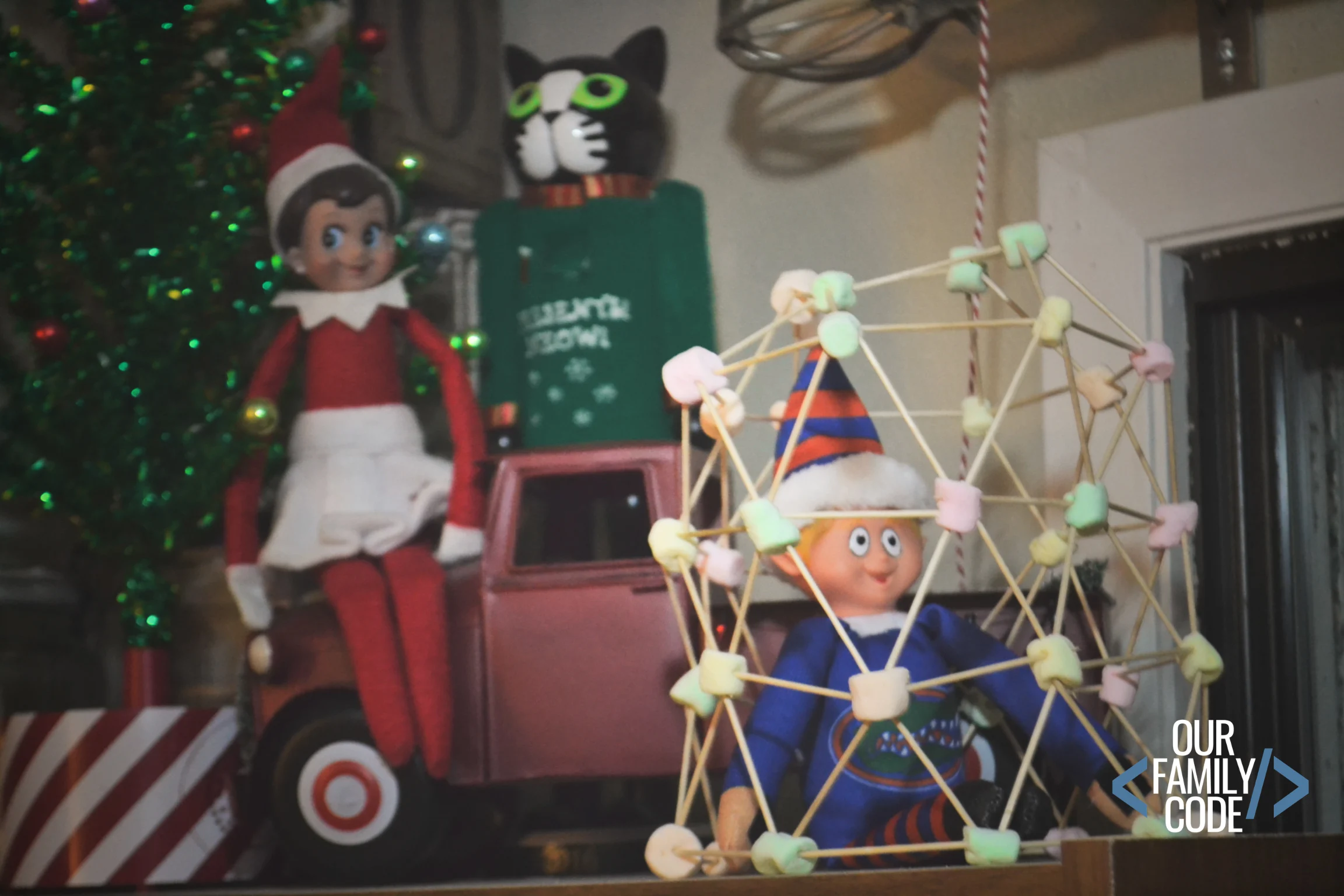 A picture of an elf on the shelf trapped in a marshmallow toothpick structure.