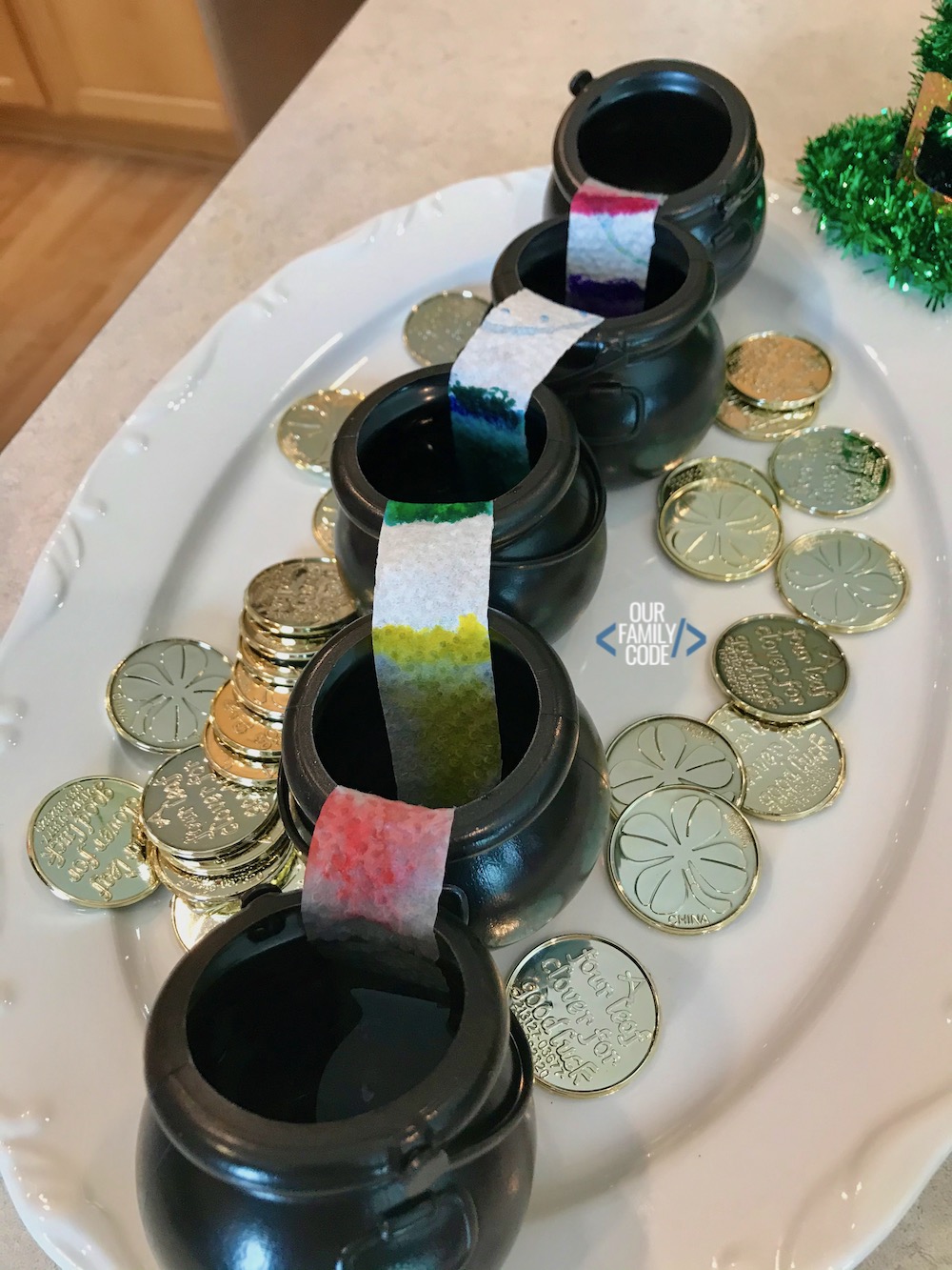 a picture of black cauldrons with rainbow paper towels on white plate.