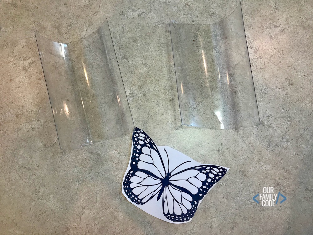 A picture of a black and white butterfly printed with a plastic water bottle cut in half.