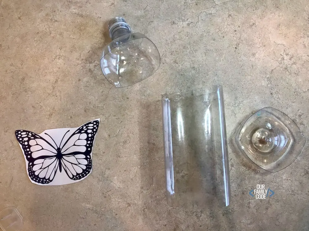 A picture of a butterfly paper with a plastic bottle with top and bottom cut off.