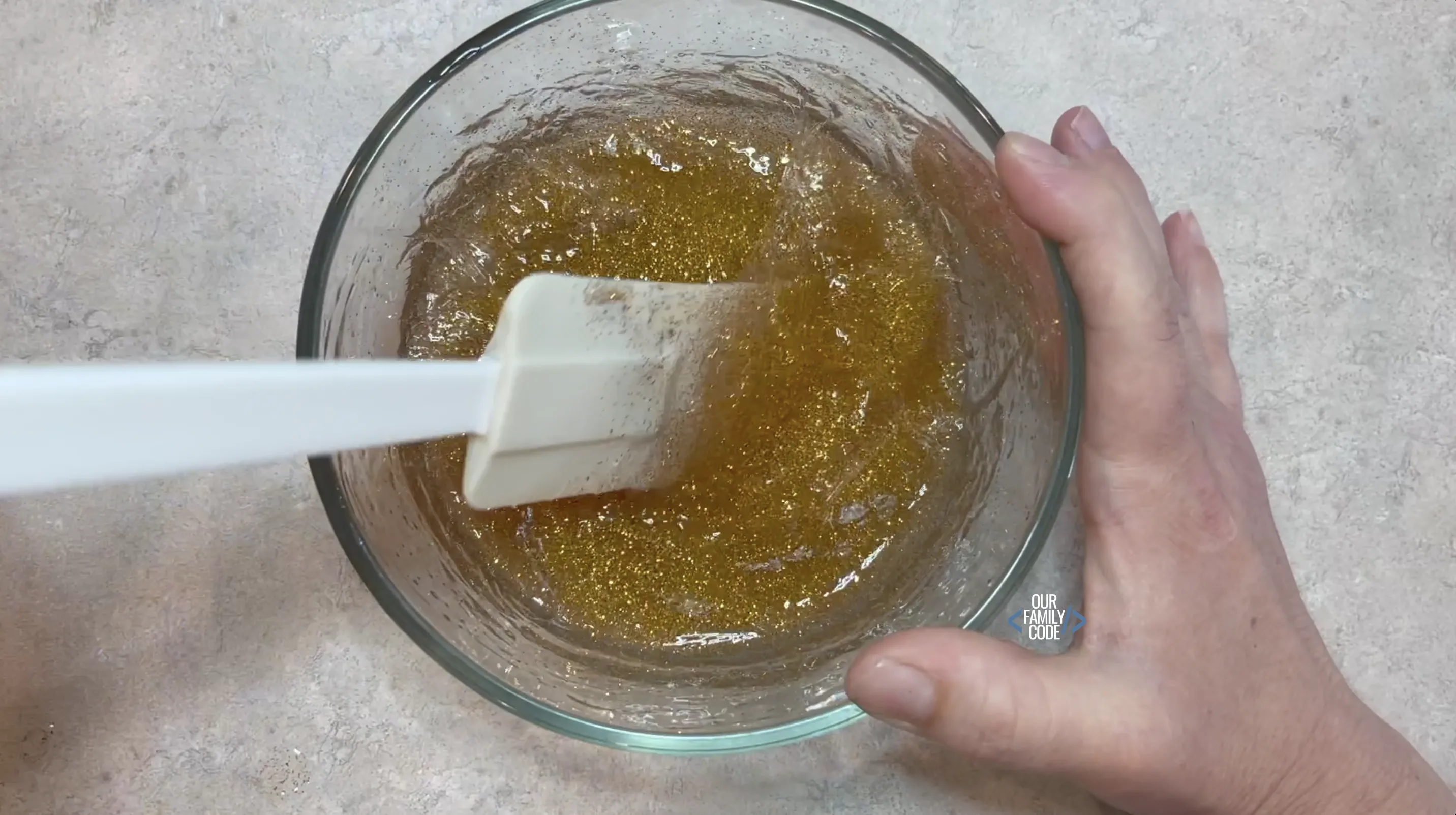 A picture of a saline slime recipe step add saline and stir until slime pulls away from sides of bowl.