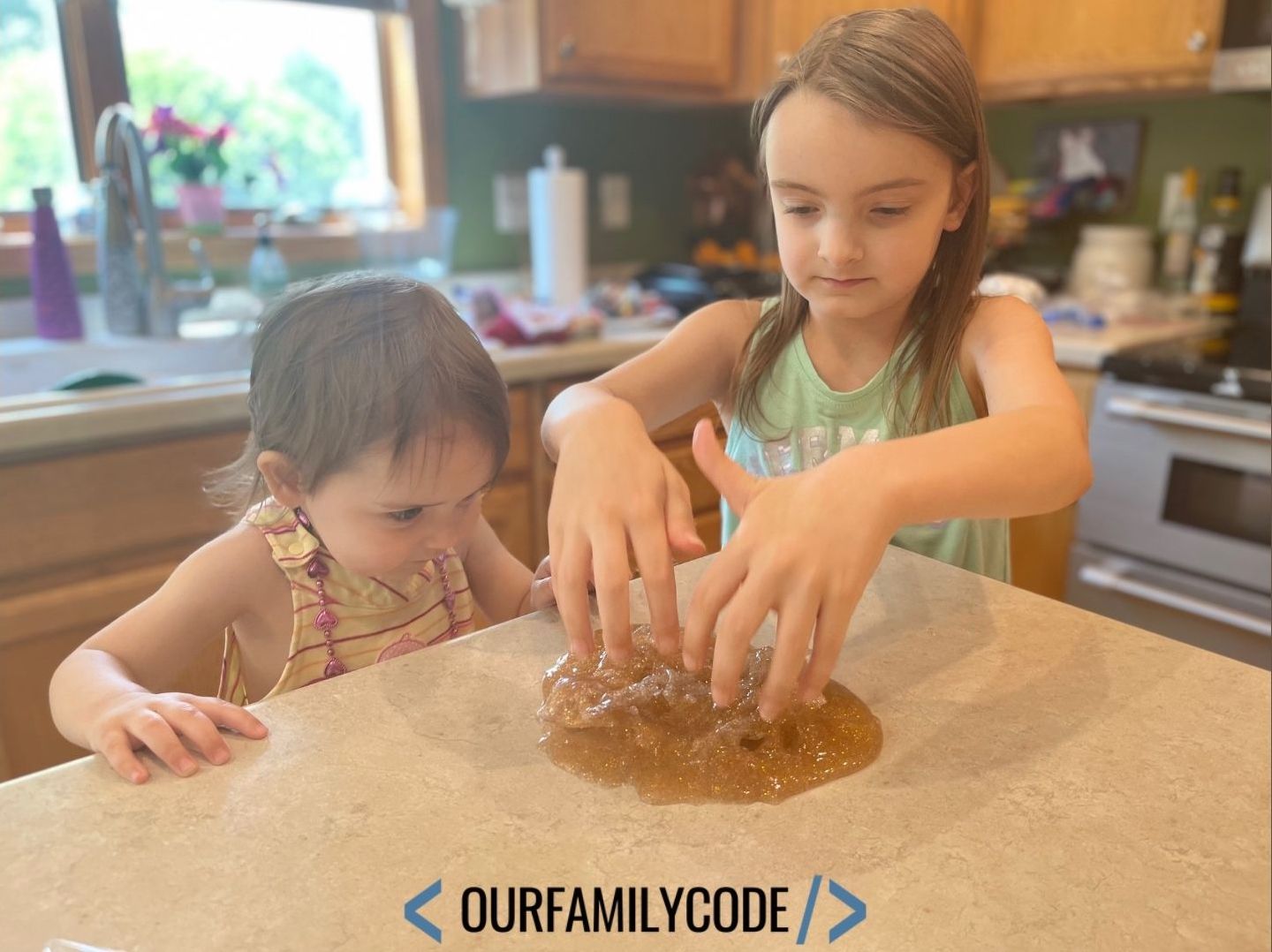 A picture of kids playing with gold glitter slime.