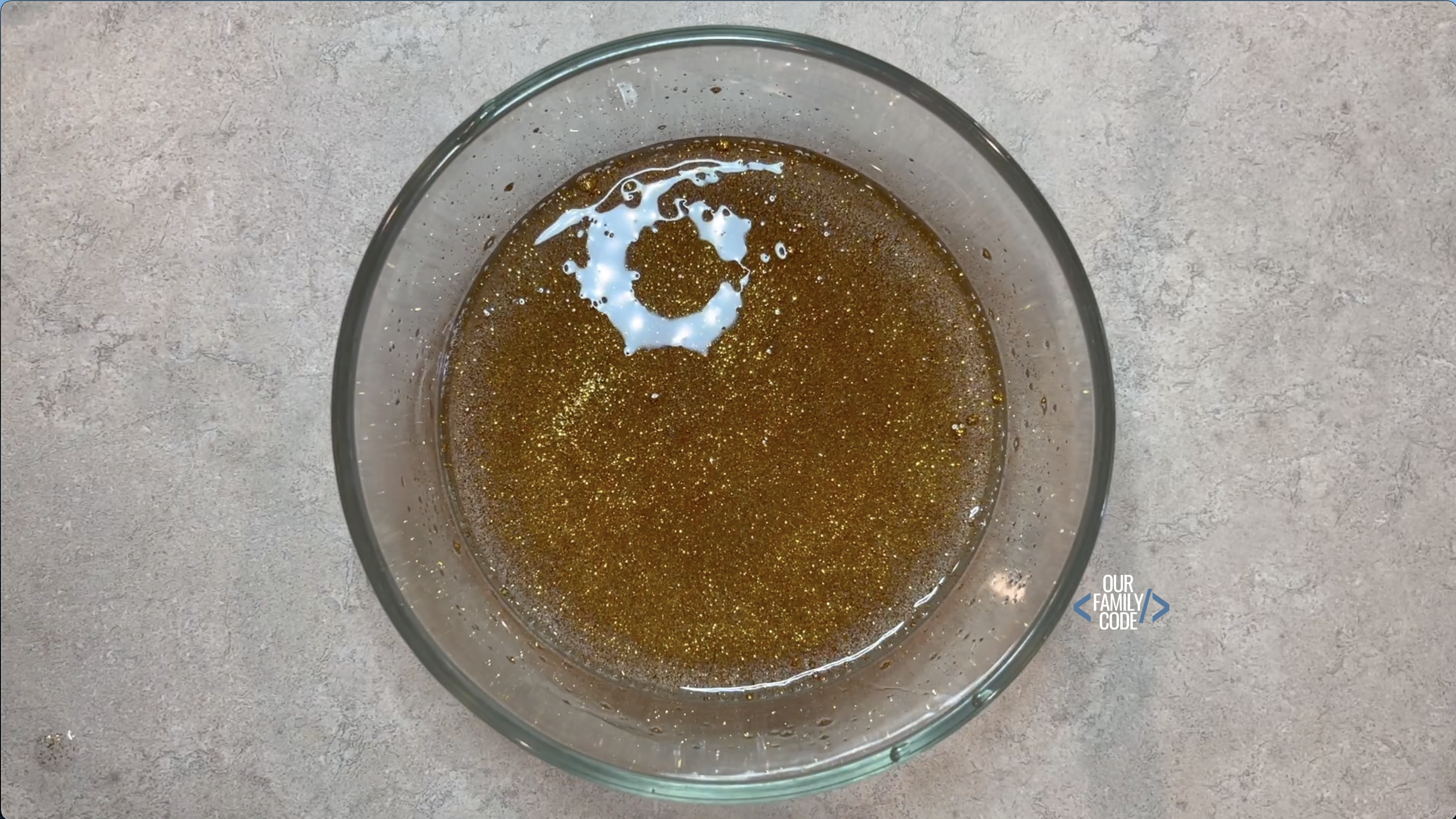 A picture of gold glitter added to slime.